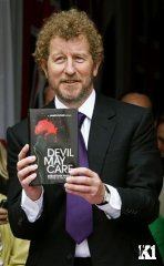 Sebastian Faulks holding Devil May Care